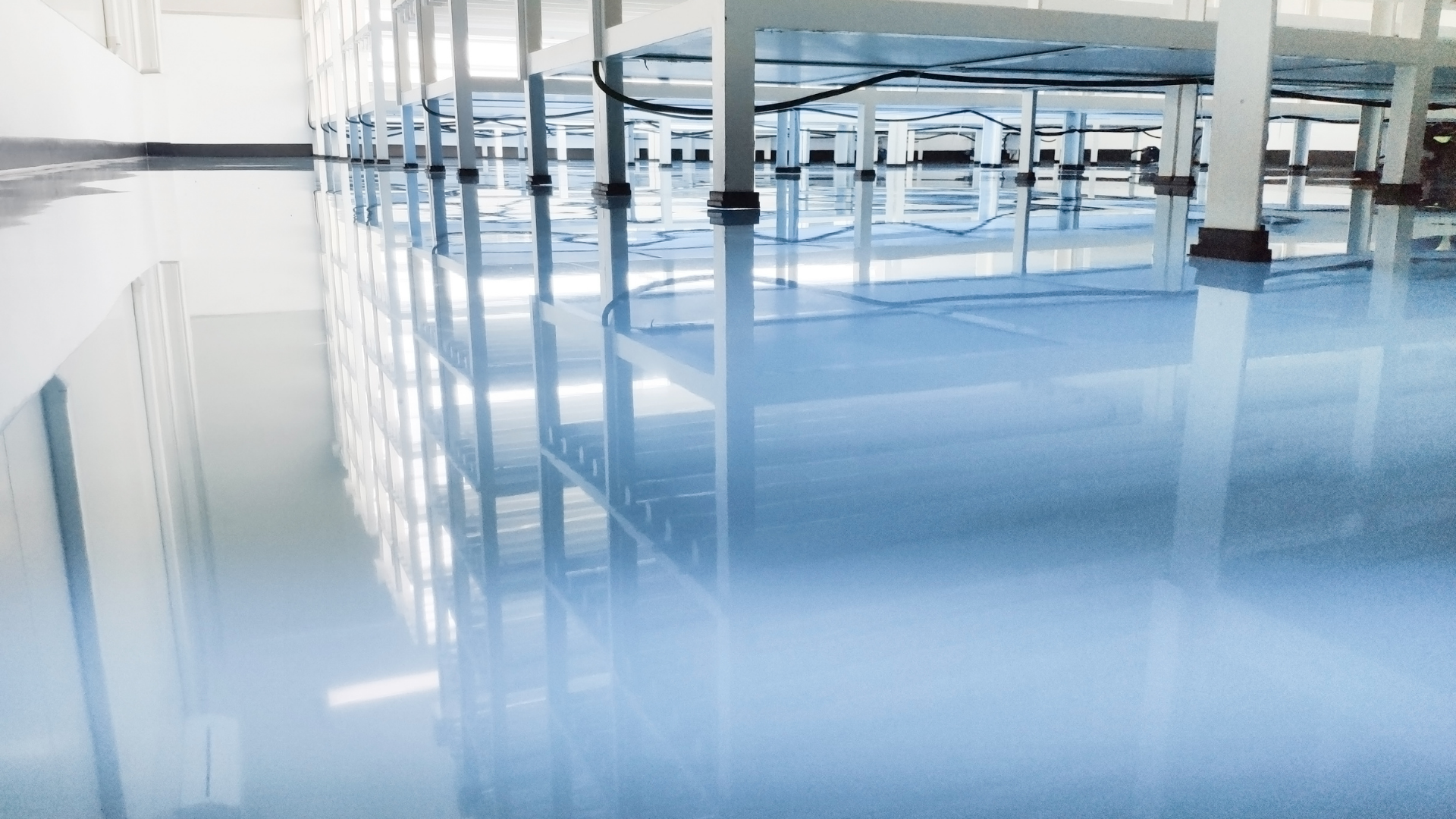 Empty living room with tan tile floor, arched windows, and fireplace.