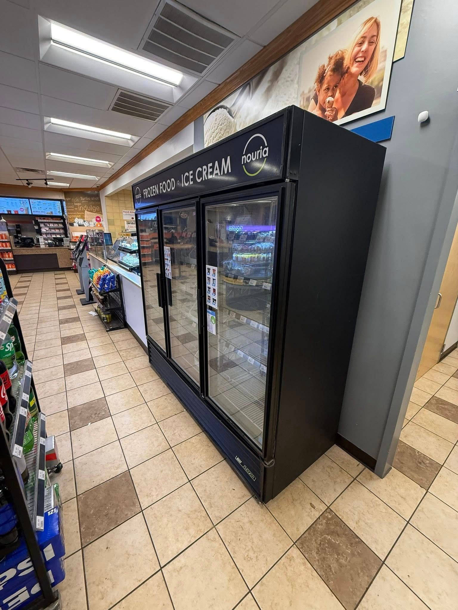 A black three-door reach-in freezer labeled 