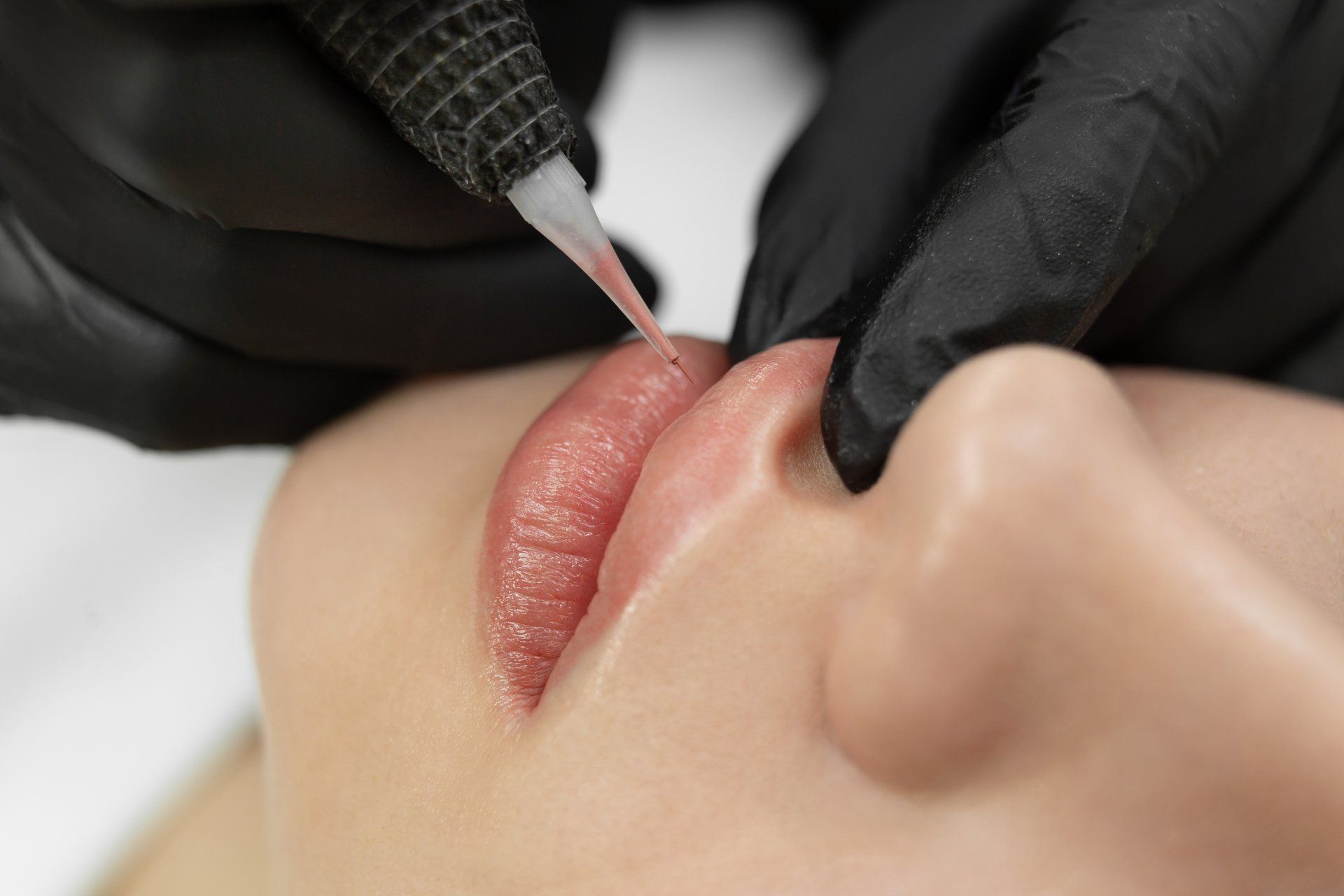 closeup of cosmetic lip tattoo process
