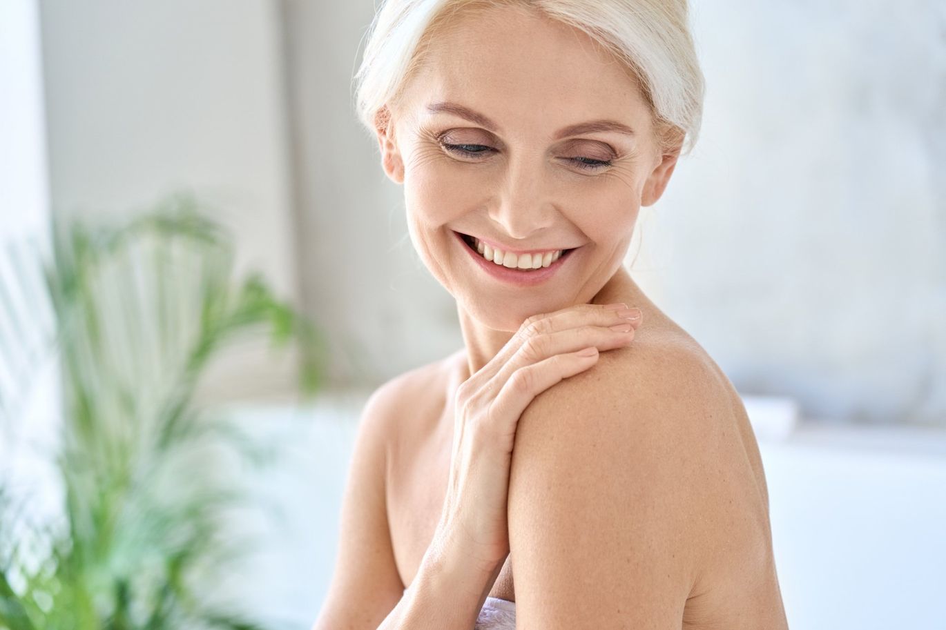 happy smiling mid aged woman touching her shoulder