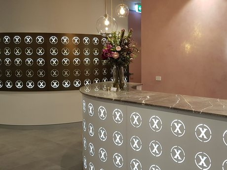 A reception desk with a vase of flowers on it