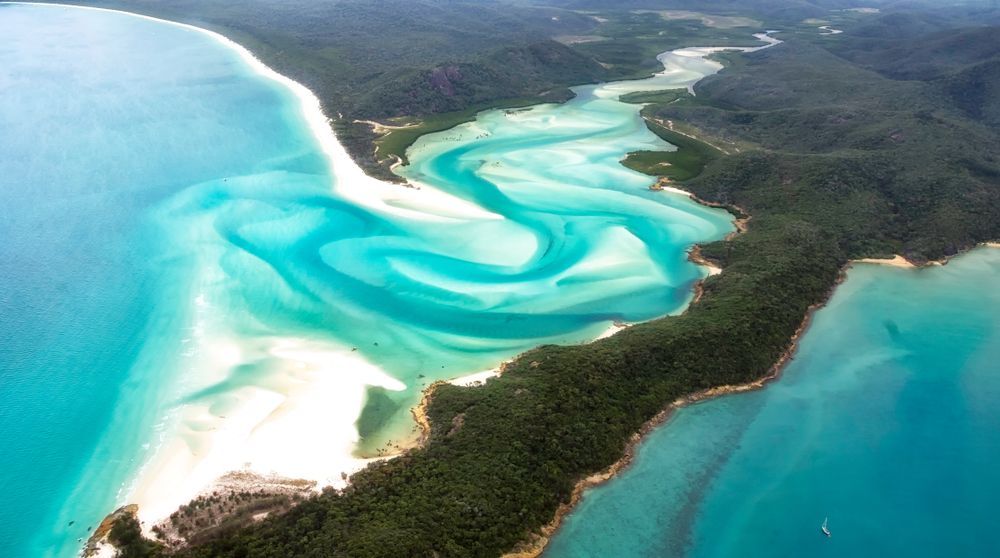 An Aerial View Of A Large Body Of Water With A River Running Through It — Brian Martin's Sheet Metal In Whitsundays, QLD