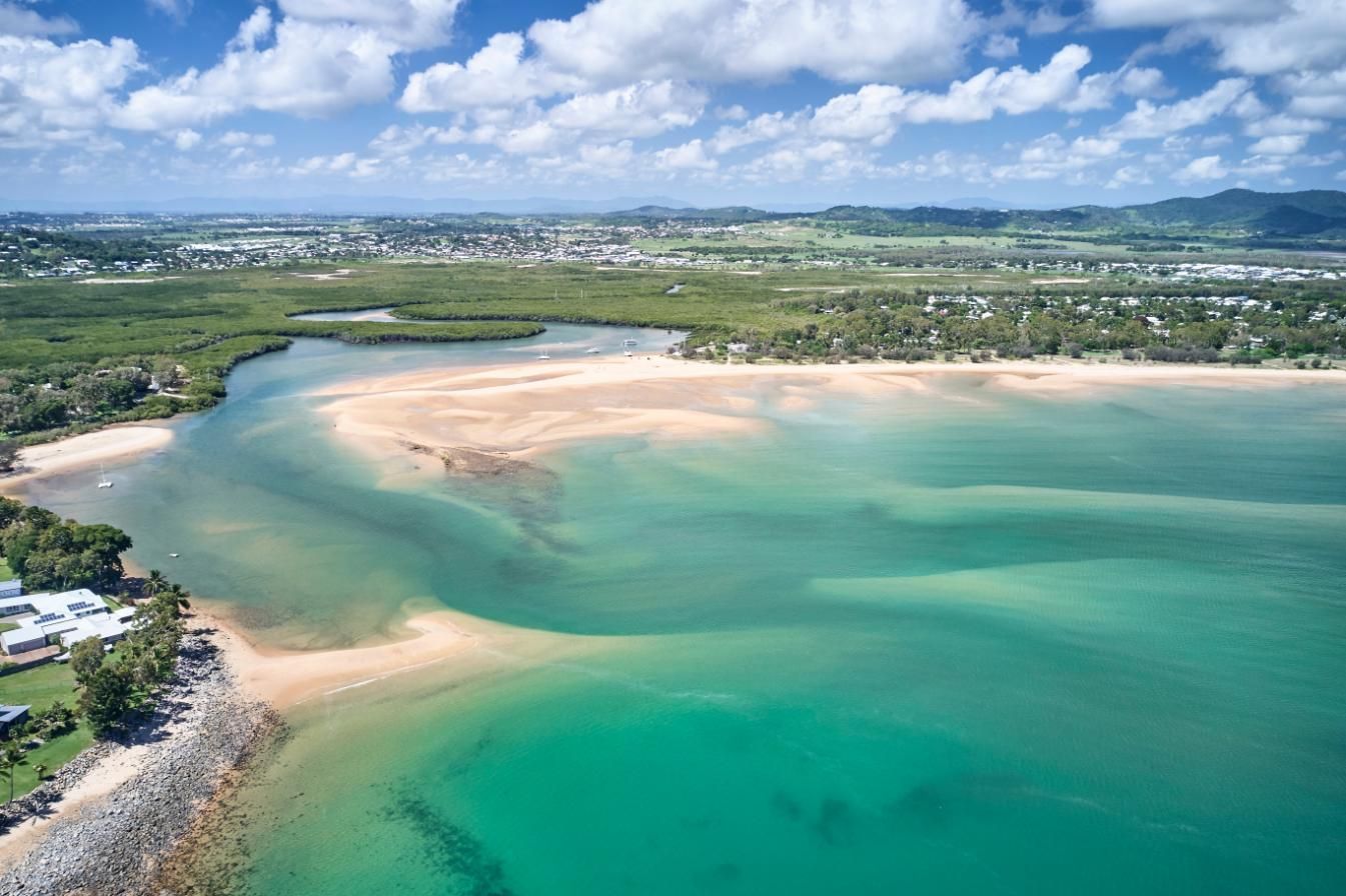 An Aerial View Of A Large Body Of Water With A Sandy Beach — Brian Martin's Sheet Metal In Whitsundays, QLD