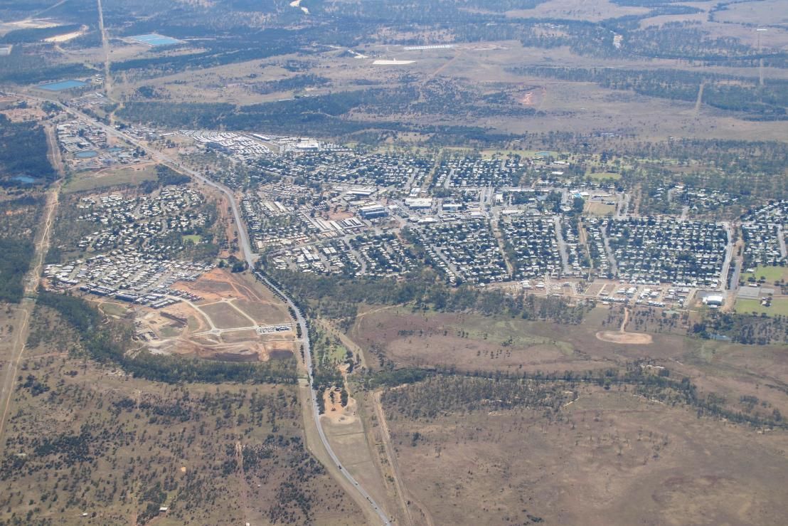 An Aerial View Of A Small Town Surrounded By Trees And Fields — Brian Martin's Sheet Metal In Moranbah, QLD