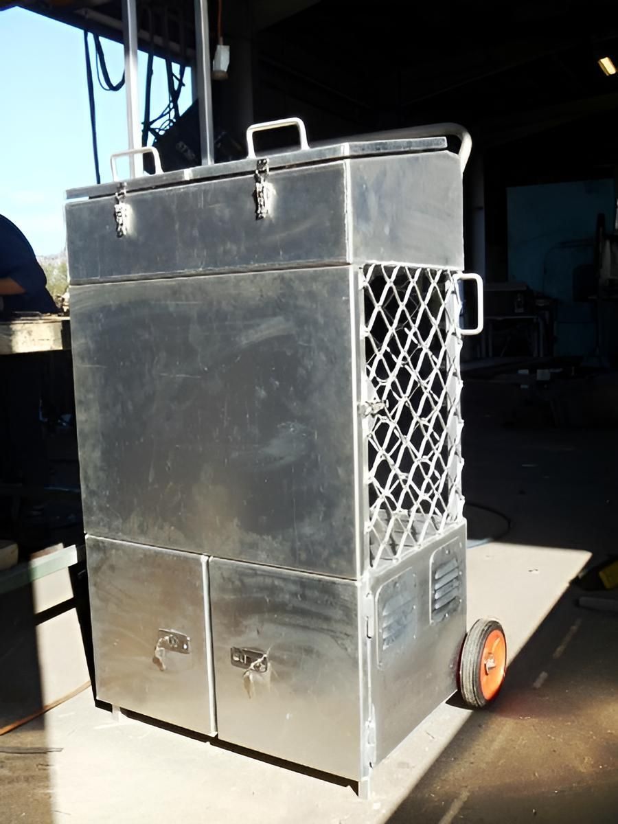 A Stainless Steel Box With Wheels Is Sitting On The Ground — Brian Martin's Sheet Metal In North Mackay, QLD