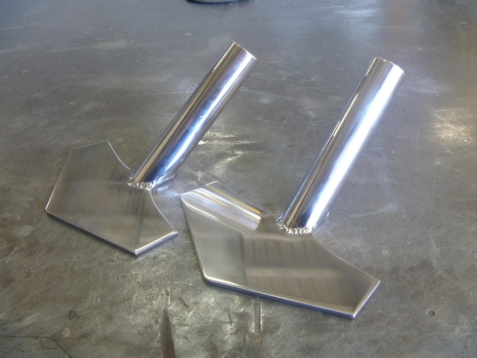 A Pair Of Stainless Steel Shovels Are Sitting On A Table — Brian Martin's Sheet Metal In North Mackay, QLD