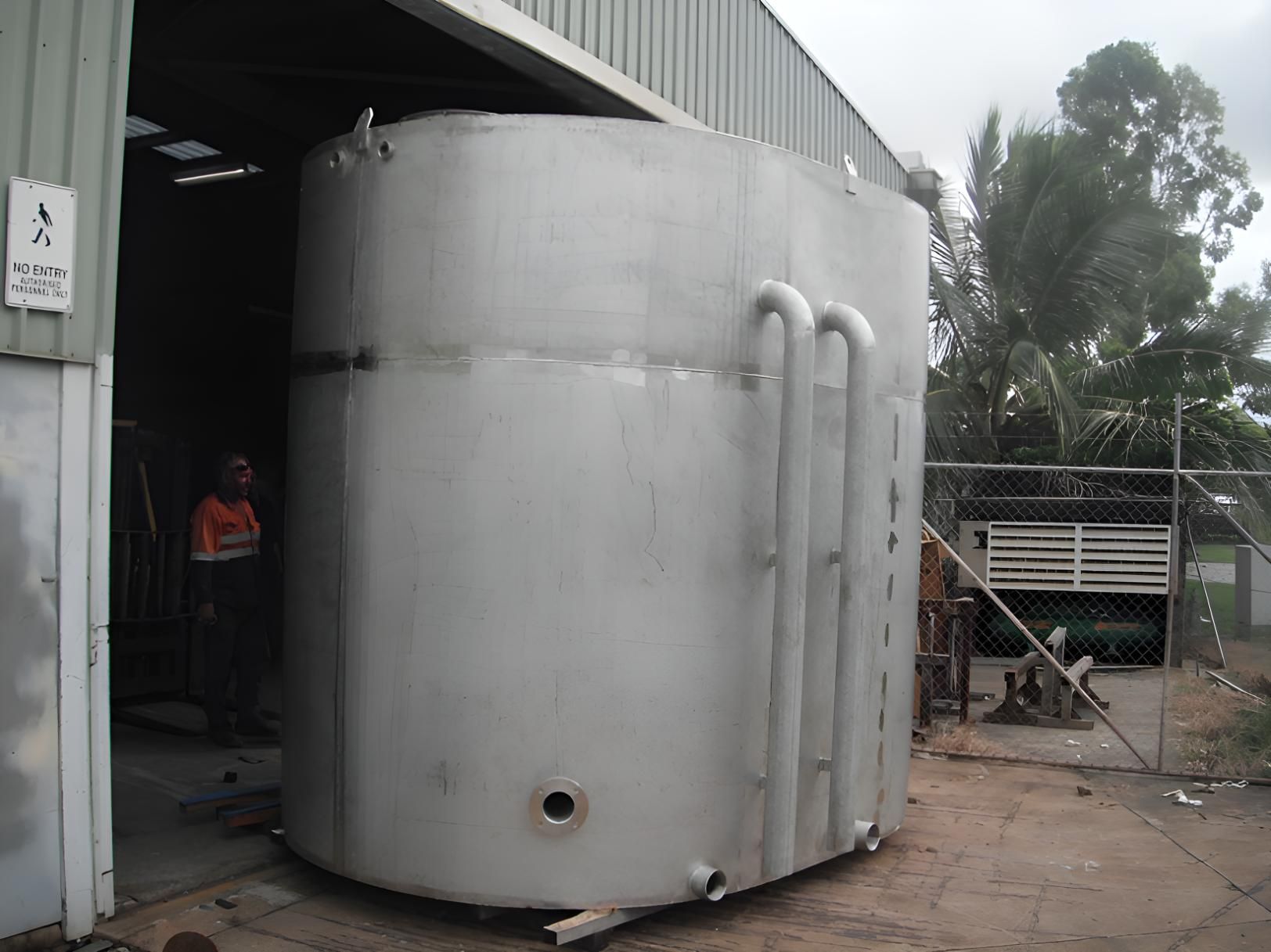 A Large Stainless Steel Tank Is Sitting Outside Of A Building — Brian Martin's Sheet Metal In North Mackay, QLD