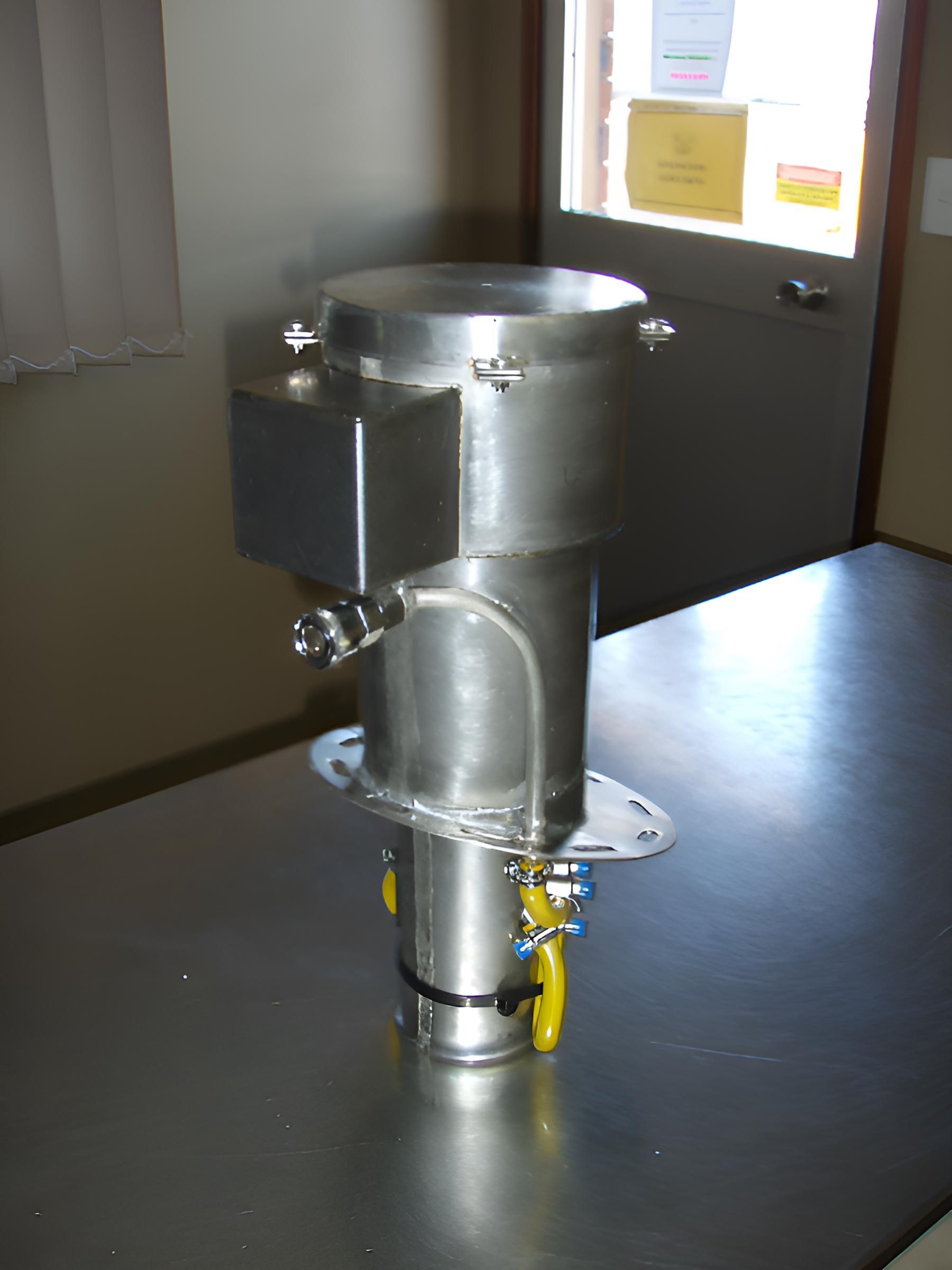 A Stainless Steel Cylinder With Yellow Handles Sits On A Table — Brian Martin's Sheet Metal In North Mackay, QLD