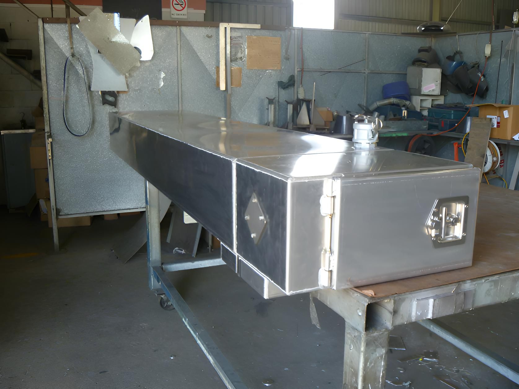 A Stainless Steel Box Is Sitting On Top Of A Wooden Table — Brian Martin's Sheet Metal In North Mackay, QLD