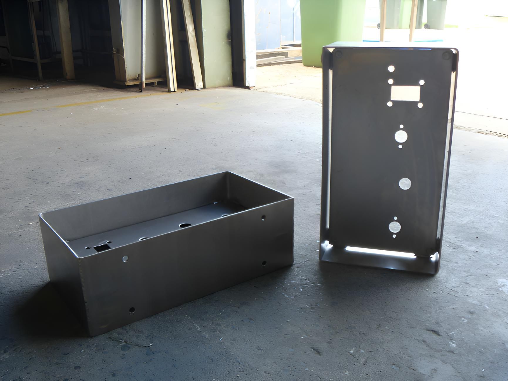 Two Metal Boxes Are Sitting On A Concrete Floor — Brian Martin's Sheet Metal In North Mackay, QLD
