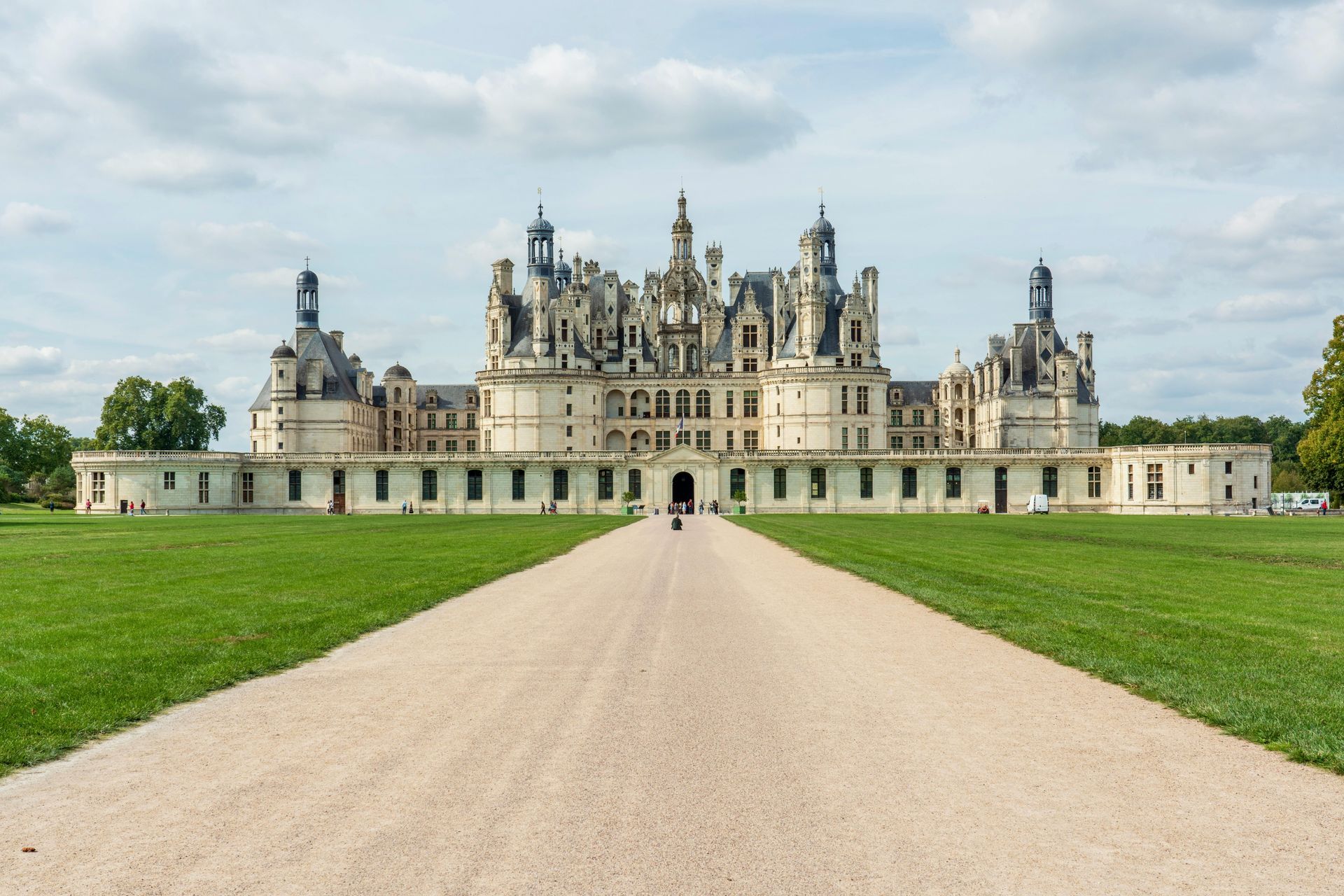 View of Château de Chambord surrounded by lush forests in the Loire Valley.