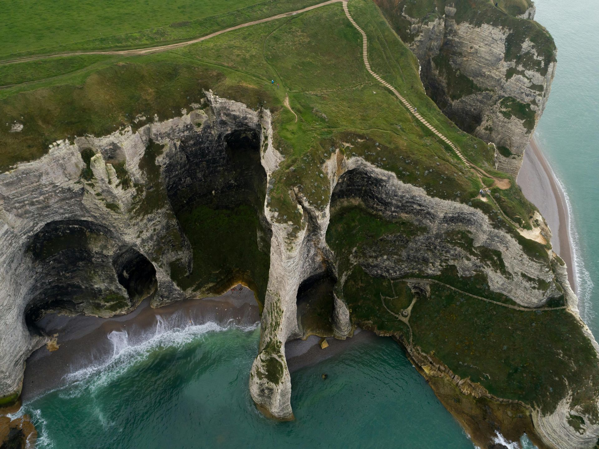 Stunning aerial shot of the white limestone cliffs of Étretat, Normandy, famous for their natural arches.