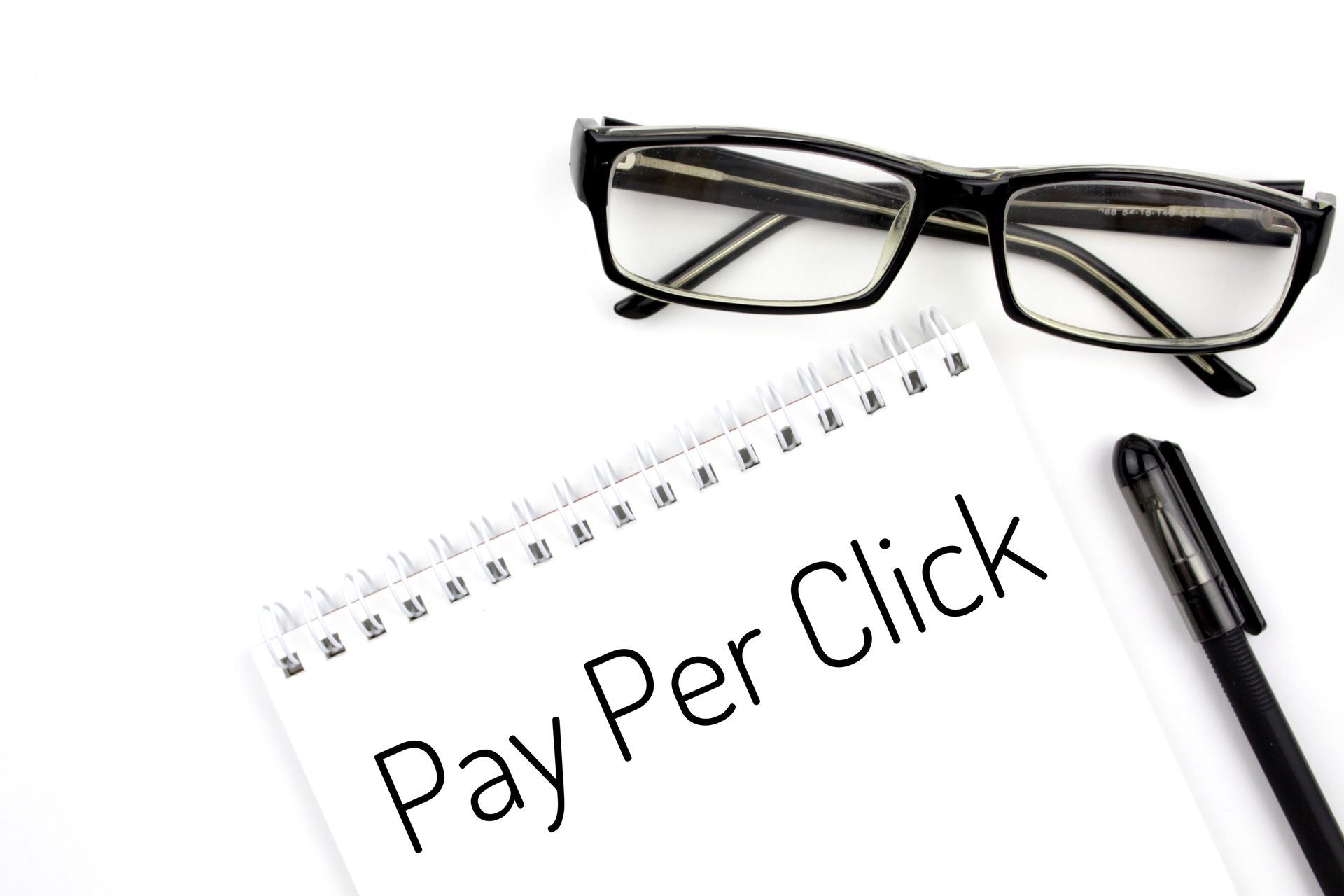 A notebook with the words pay per click written on it