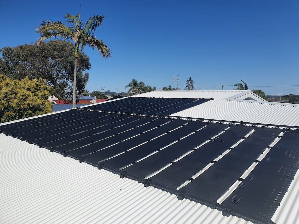 A White Roof With Solar Panels on It — Solar Services in Erina, NSW
