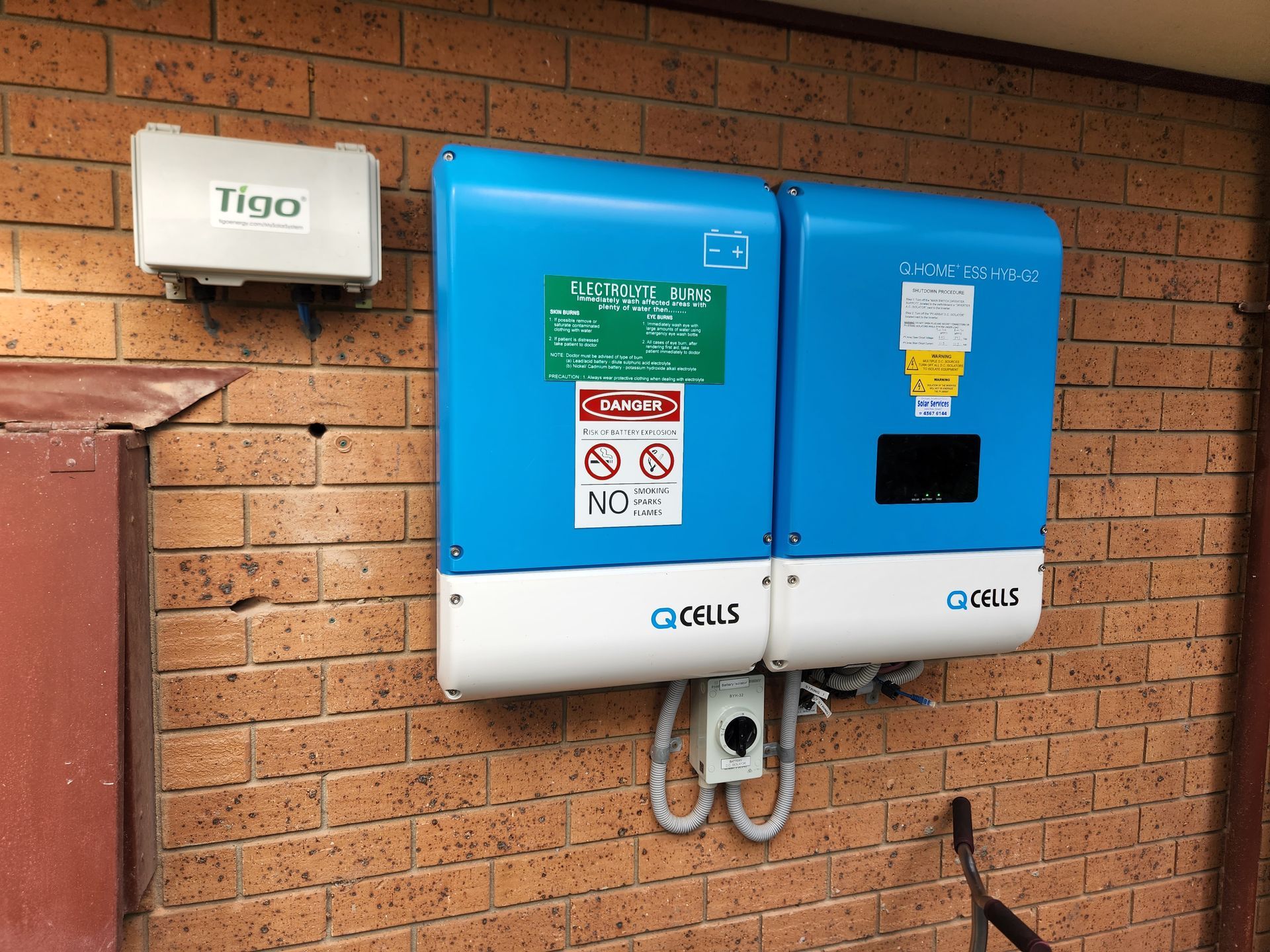 A solar energy box fixed to a brick wall — Solar Services in Erina, NSW