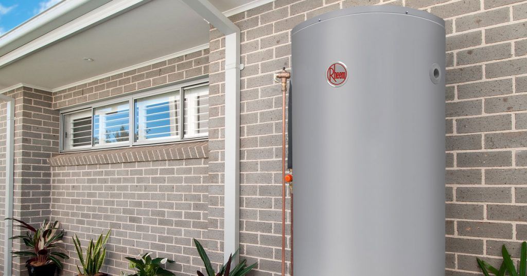 a large water heater outside a brick house — Solar Services in Erina, NSW
