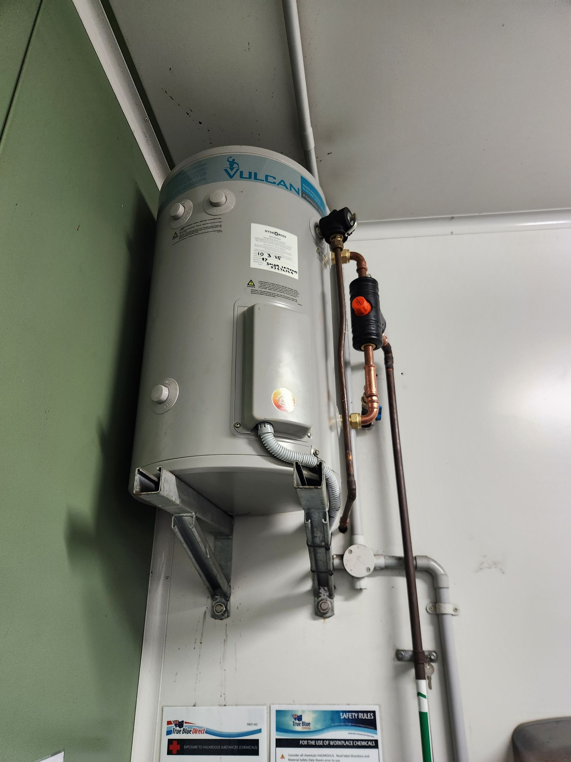A Water Heater is mounted on a wall — Solar Services in Erina, NSW
