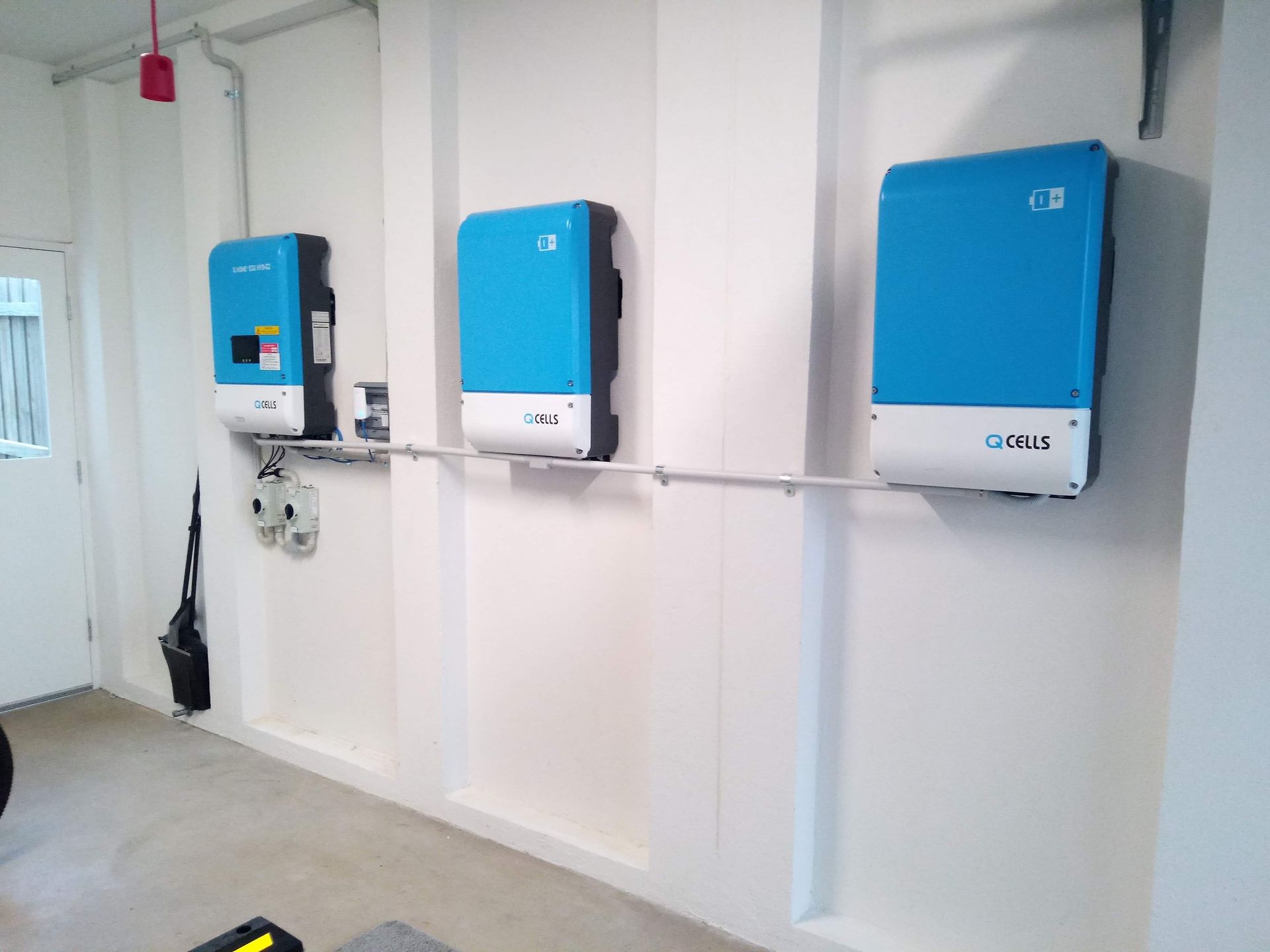 Three bleu and White Boxes Are Hanging on a Wall Next to Each Other — Solar Services in Erina, NSW