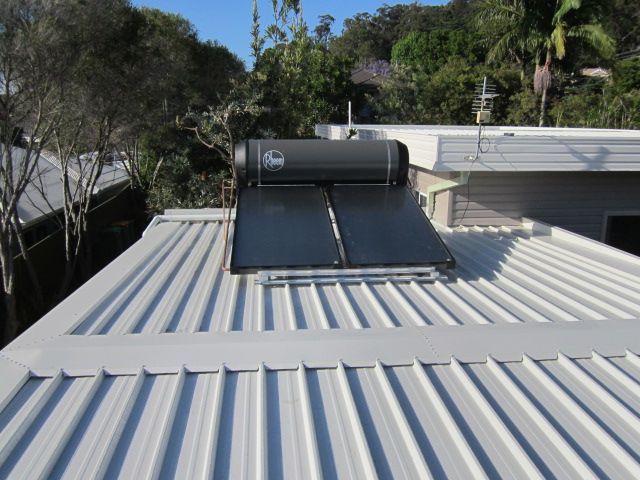 A water heating system on top of a roof — Solar Services in Erina, NSW