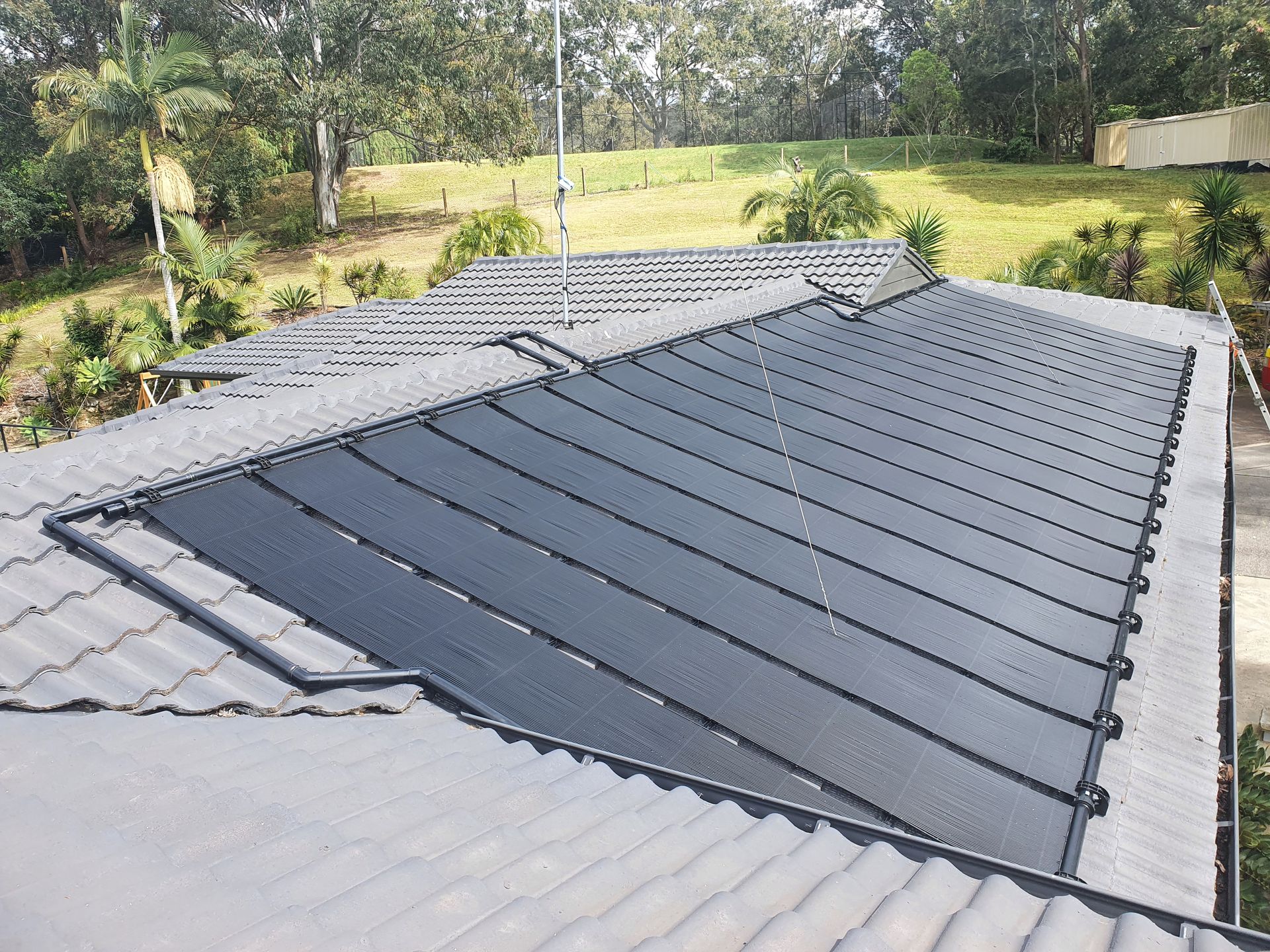solar water heating panels on a roof — Solar Services in Erina, NSW