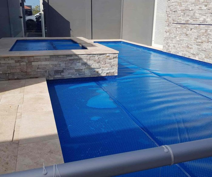 Pool Covered With Blue Blanket — Solar Services in Erina, NSW