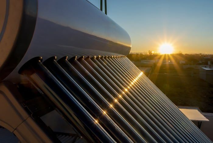 The Sun is Shining Through the Pipes of a Solar Water Heater — Solar Services in Kincumber, NSW