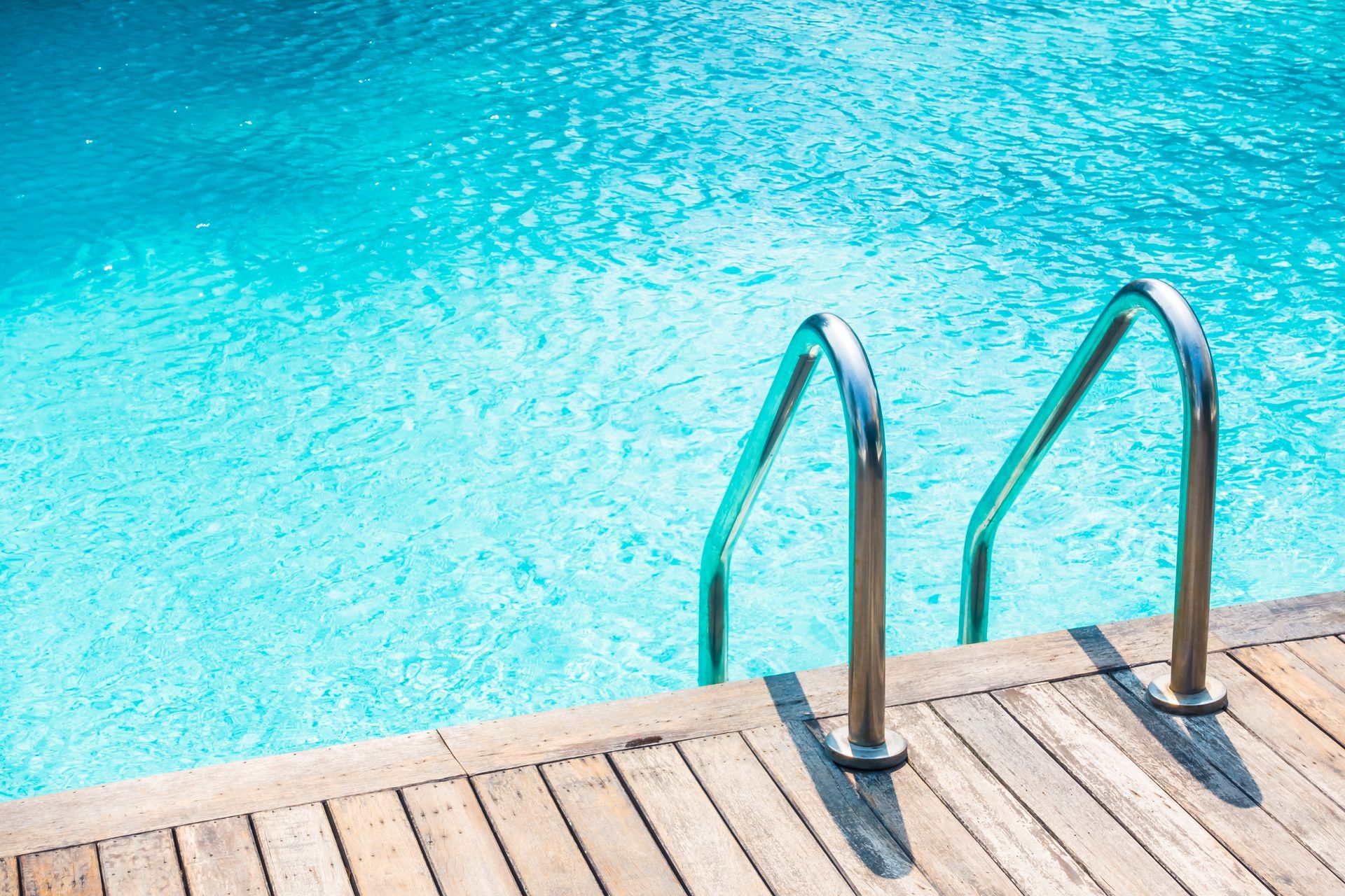 a swimming pool heater unit on a concrete pad outside a house with some grass around it — Solar Services in Erina, NSW