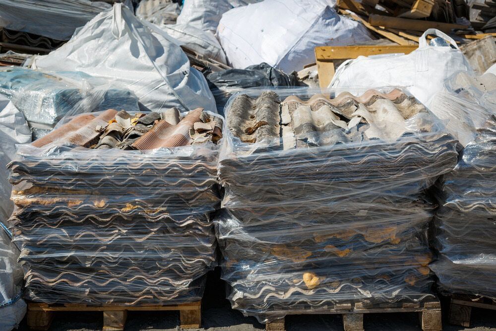 Stacks of Wrapped Roofing Tiles and Debris on Pallets, Outdoors — Hasti Skips in Ocean Shores, NSW