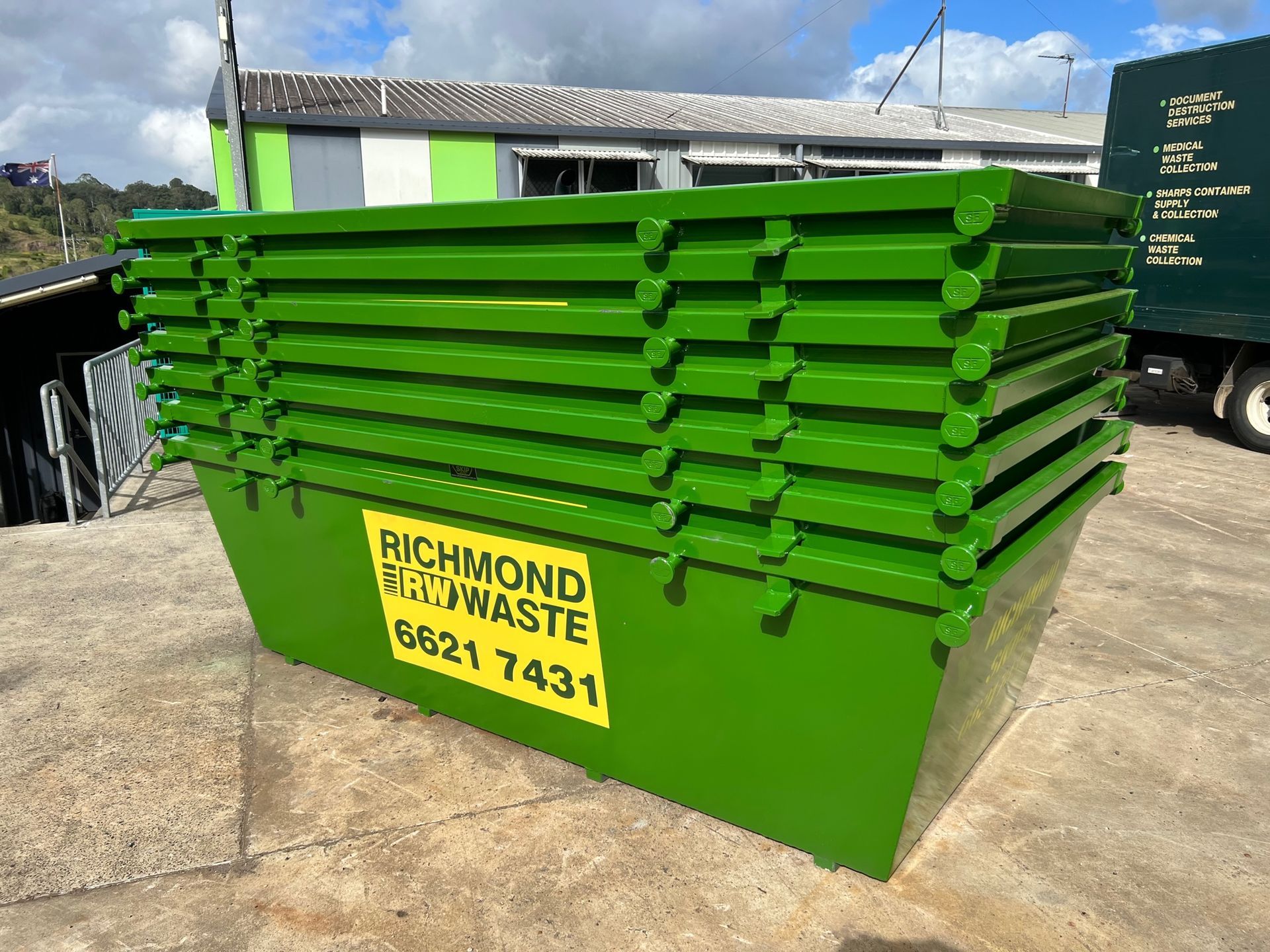 Seven Stacked Green Richmond Skips Bins — Hasti Skips in Bangalow, NSW