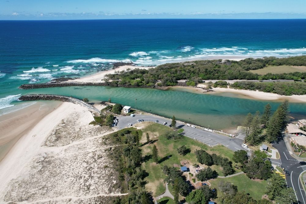 Aerial View of a Turquoise River Meeting the Ocean, With Sandy Beaches, and Trees — Hasti Skips in Kingscliff, NSW