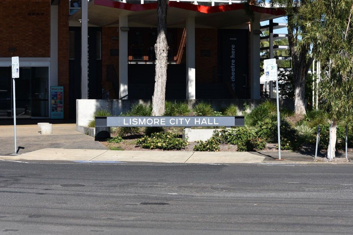 Lismore City Hall Sign, Gray With White Letters, in Front of the Building — Hasti Skips in Lismore, NSW