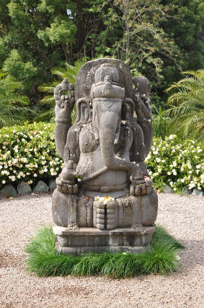 Stone Statue of Ganesha in a Garden, Gray Stone With Visible Hands, Trunk, and Ears — Hasti Skips in Mullumbimby, NSW