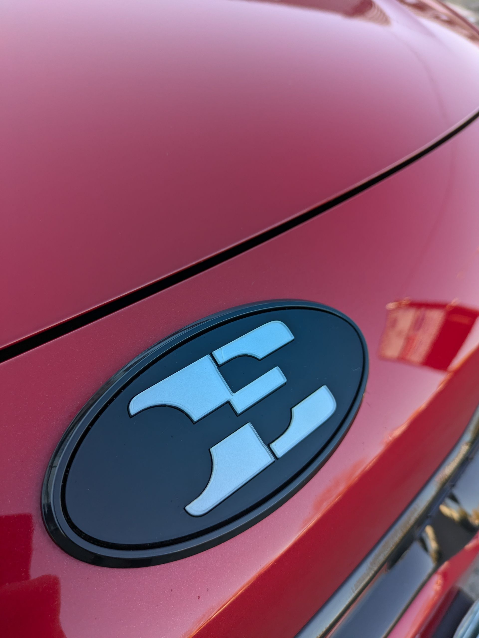 A red car with a black emblem that says e on it