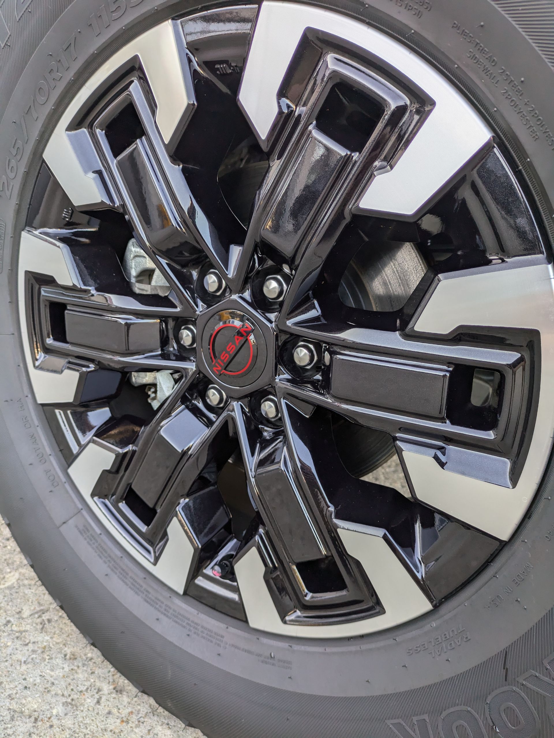A close up of a black and silver wheel on a car.