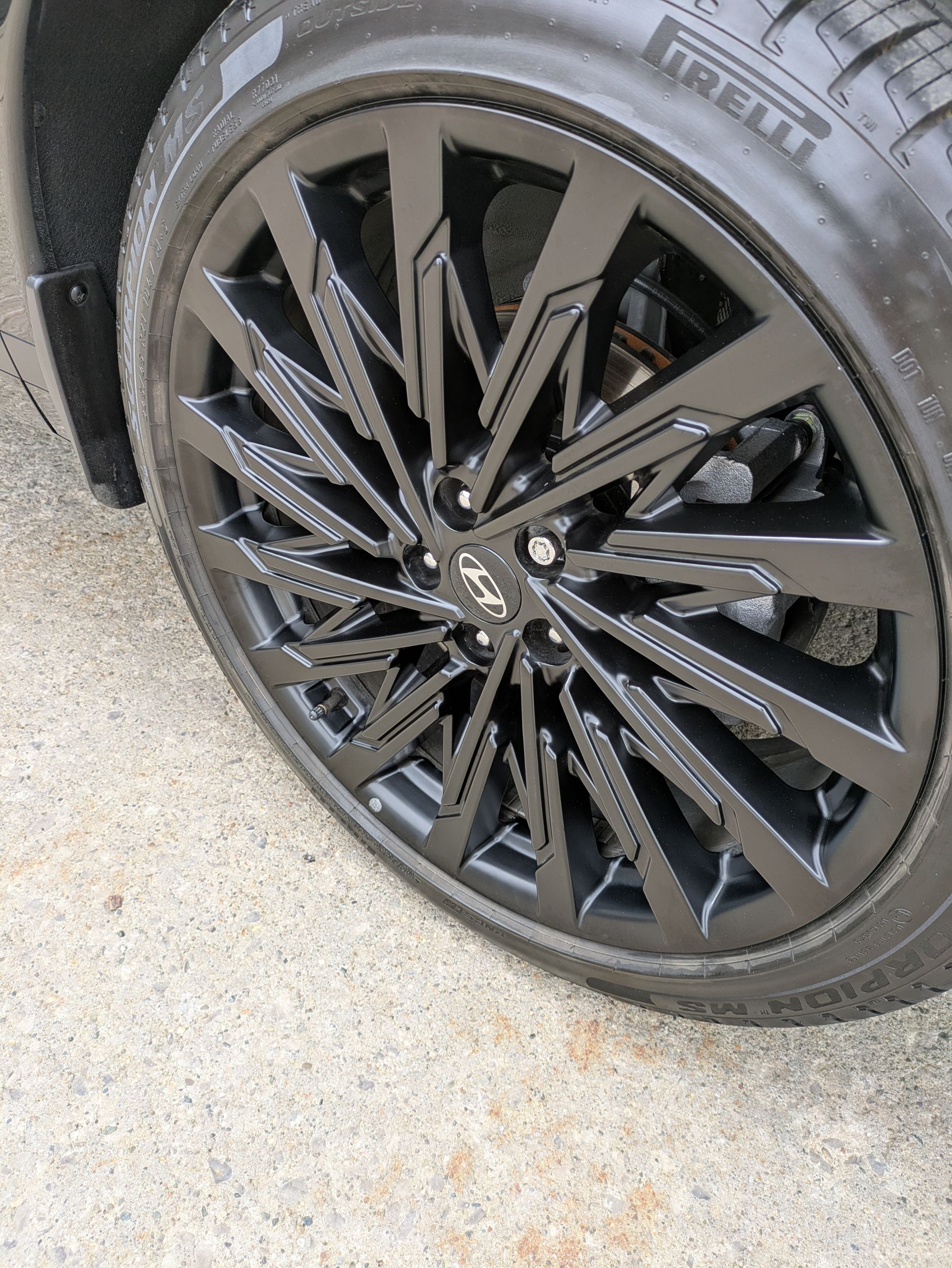 A close up of a car wheel with a tire on it.