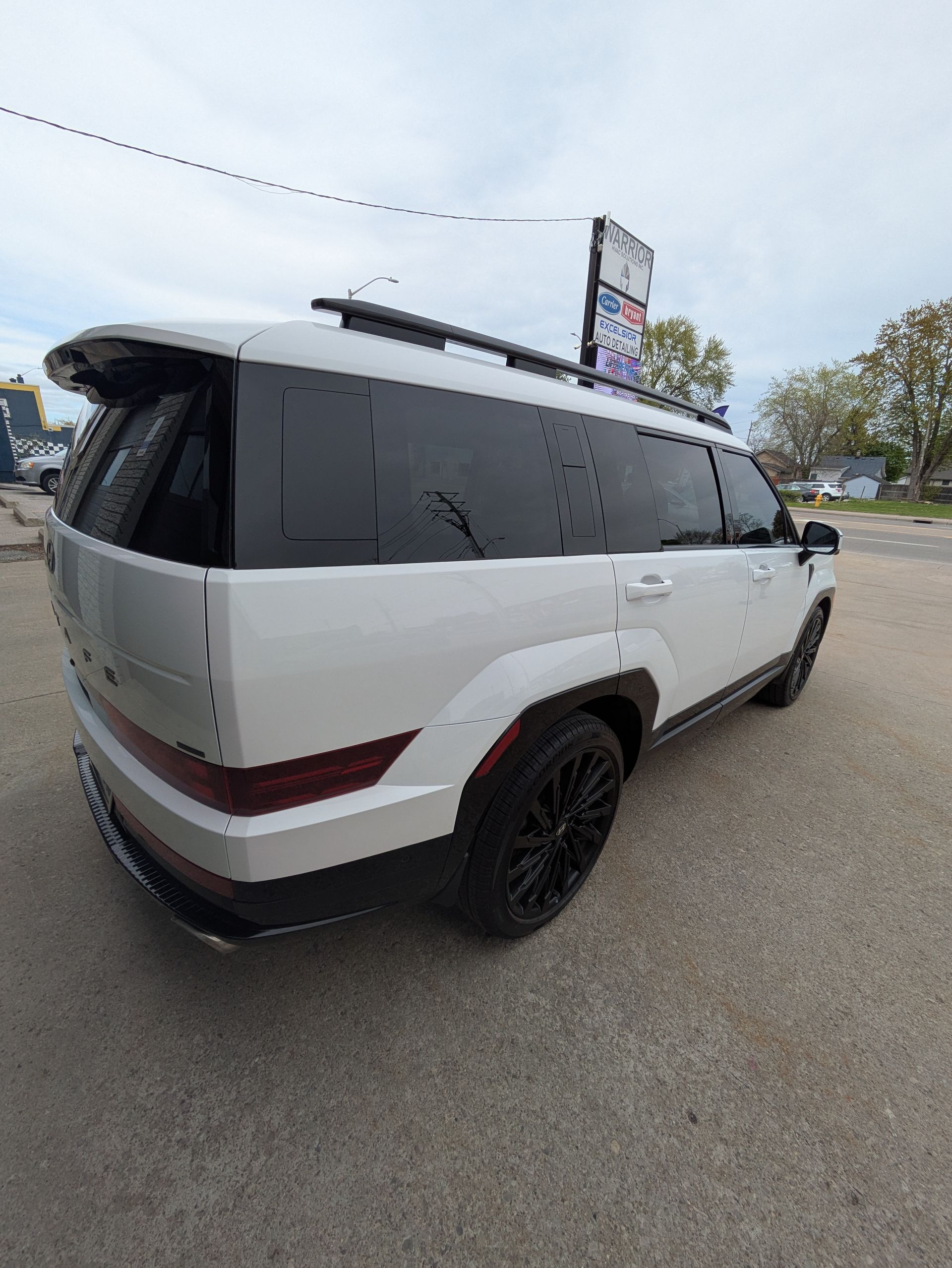 A white suv is parked in a parking lot.