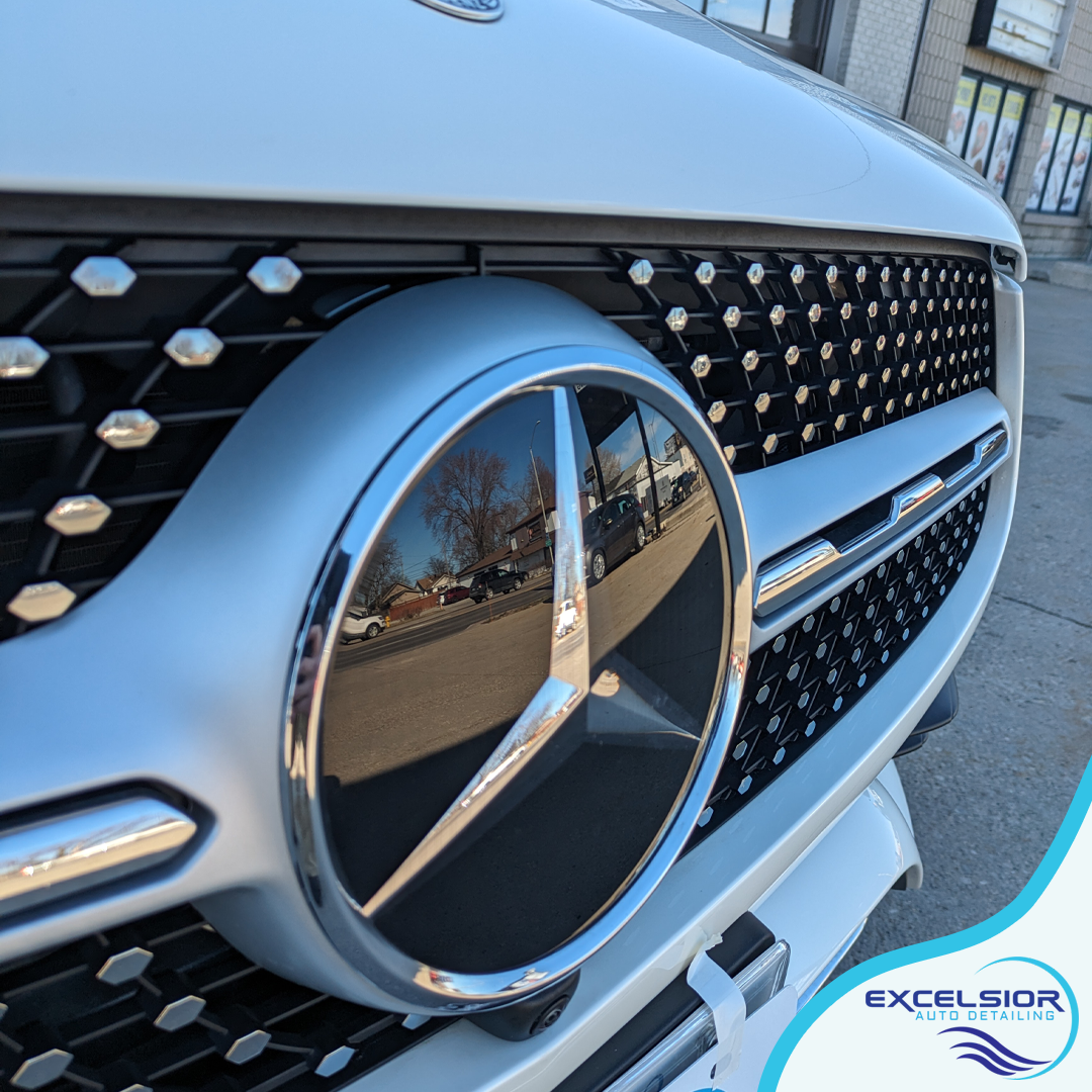 A close up of a mercedes logo on the front of a car