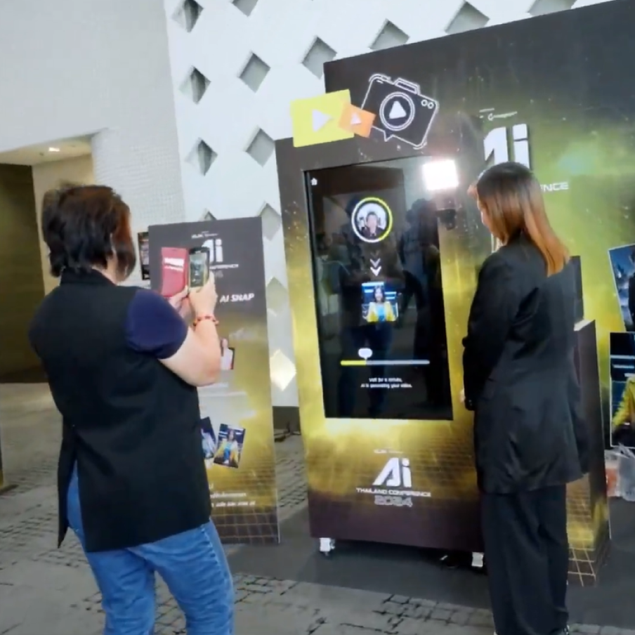 Two people viewing an AI kiosk display at an indoor event booth.