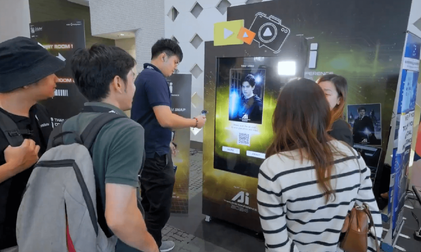 People gathered around an interactive digital display in a museum or exhibit space.