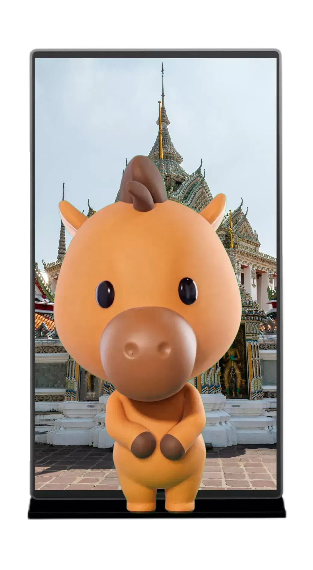 Cute orange cartoon cow figurine in front of a temple inside a black phone screen