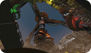 Low-angle view of a large, metallic, rotating industrial machine with orange and green accents set against a dark sky.