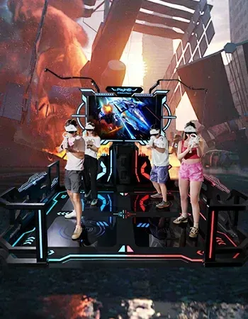 Four people wearing VR headsets and holding controllers play a video game on a lit, elevated platform with a screen.