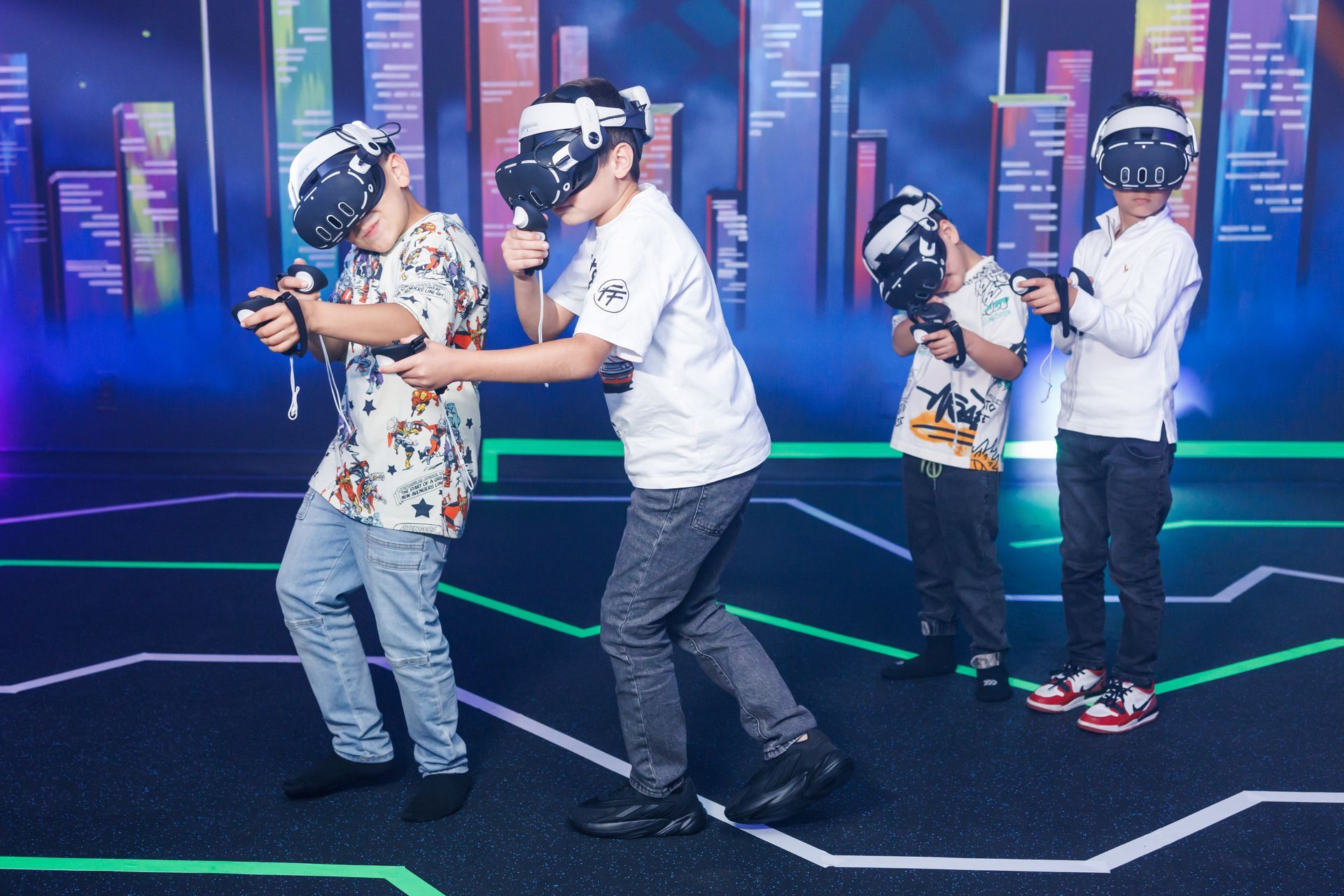 Four people wear VR headsets and hold controllers in a dark room with glowing geometric lines on the floor.