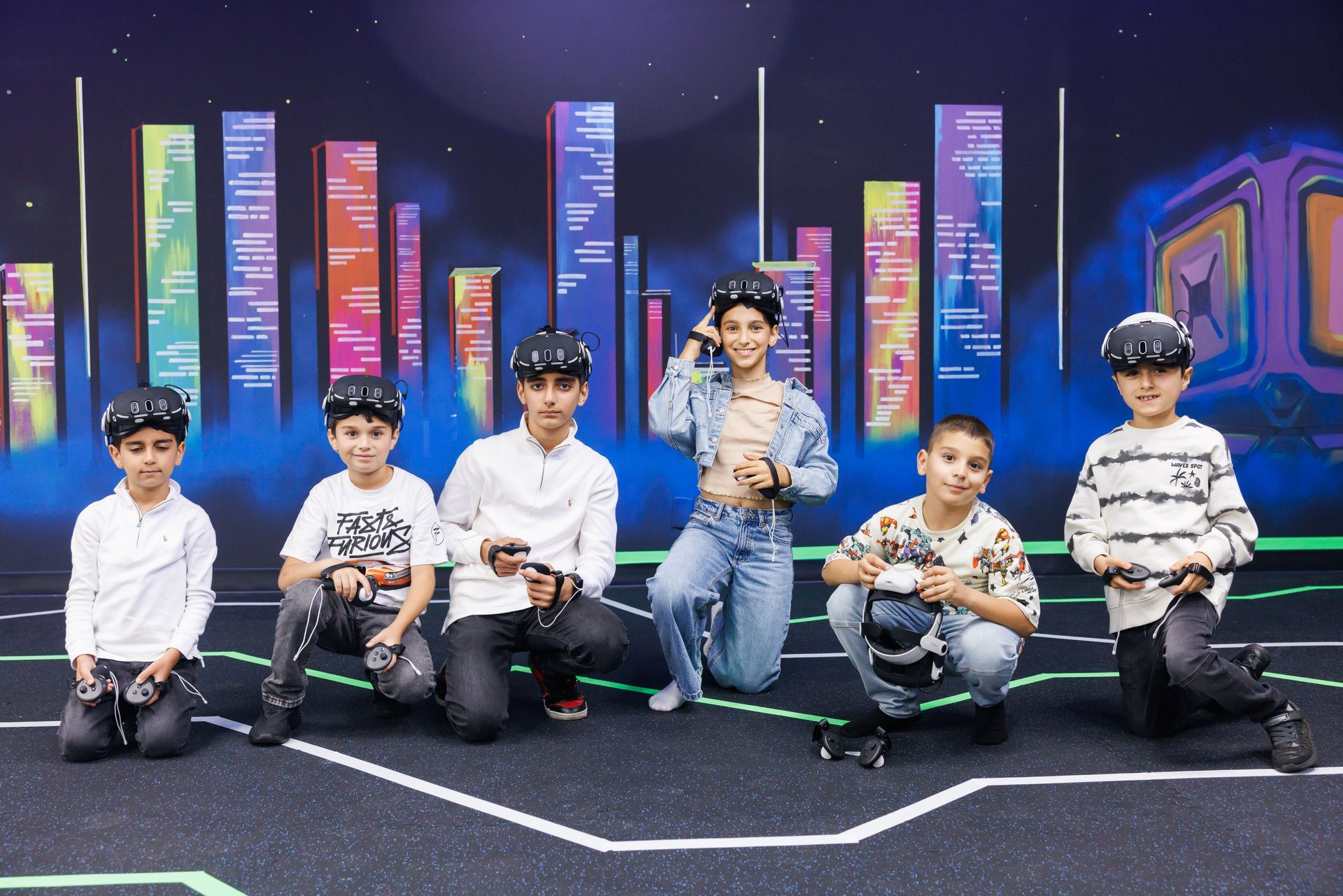 Six people wearing VR headsets pose in front of a colorful, abstract city skyline backdrop with neon floor lines.