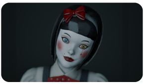 A close-up of a pale doll with dark hair, a red bow, and mismatched blue and yellow eyes against a dark background.