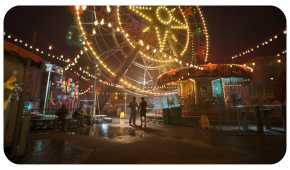 A Ferris wheel and carousel illuminated by warm string lights at a night carnival with two people standing in the center.