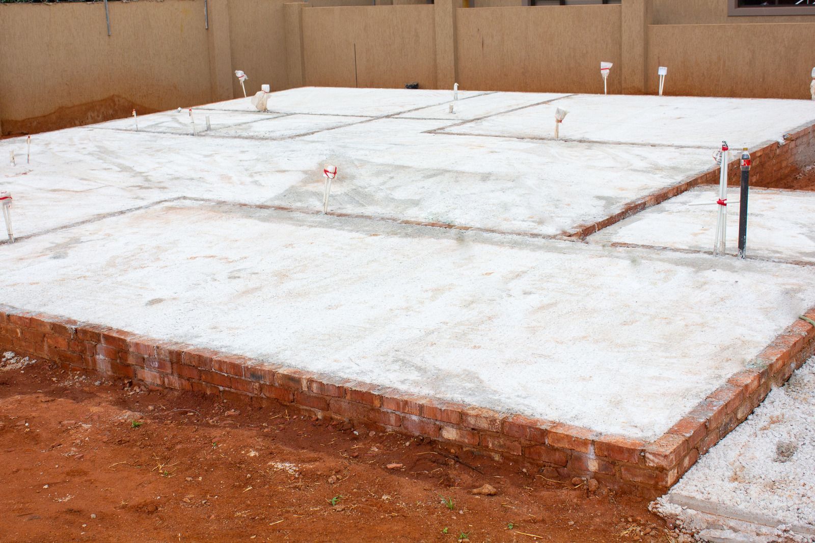A large concrete slab is sitting on top of a dirt field.