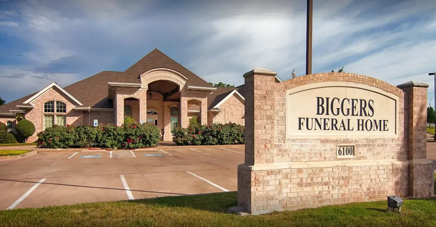 Biggers Funeral Home brick building and sign at a roadside entrance