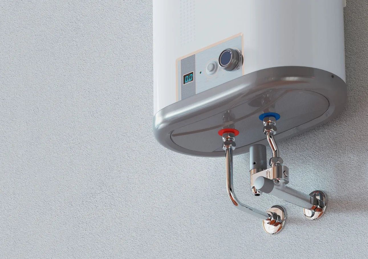 Wall-mounted electric water heater with copper piping and water supply valves.