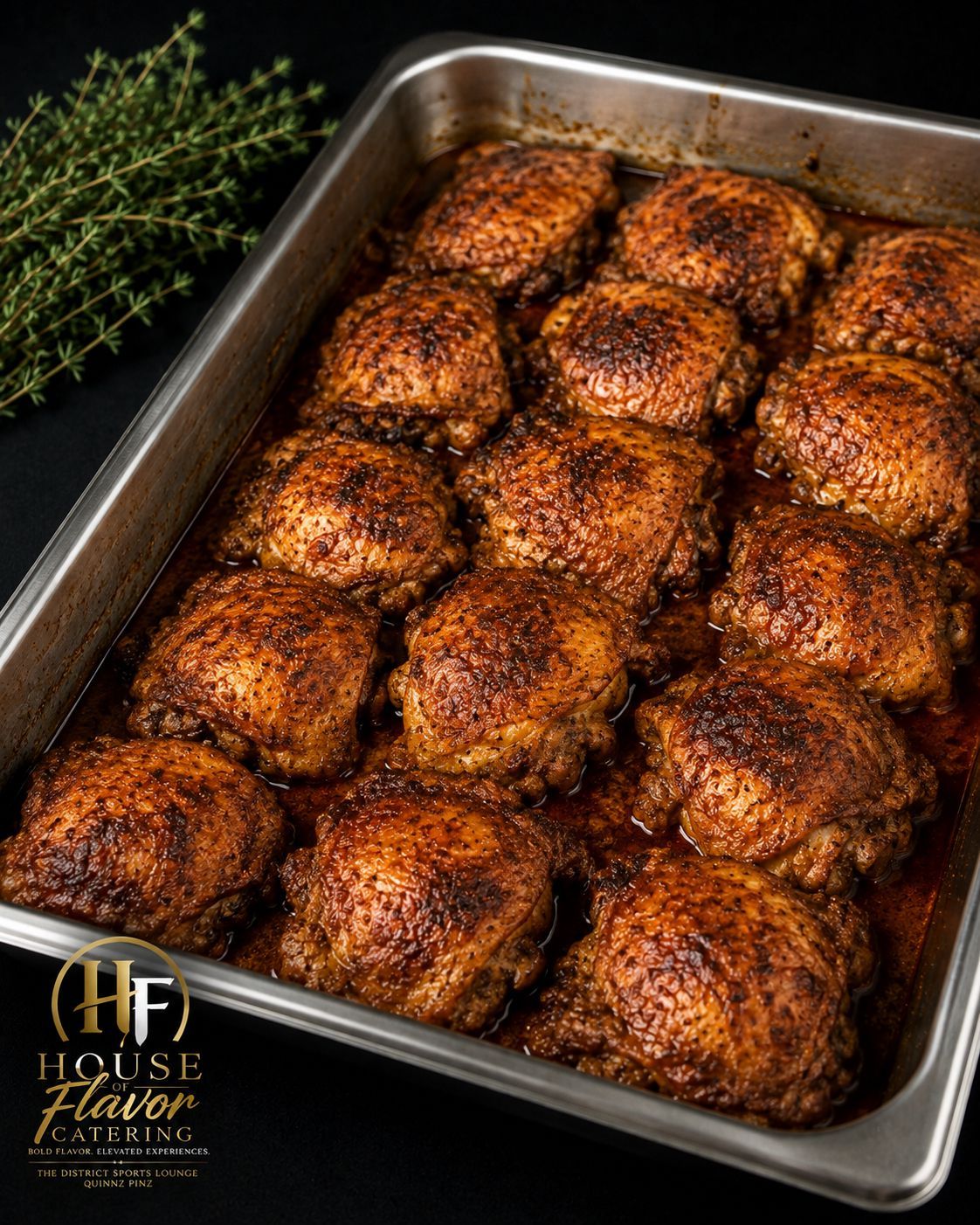 Tray of golden-brown roasted chicken thighs with crispy seasoning, garnished with thyme.